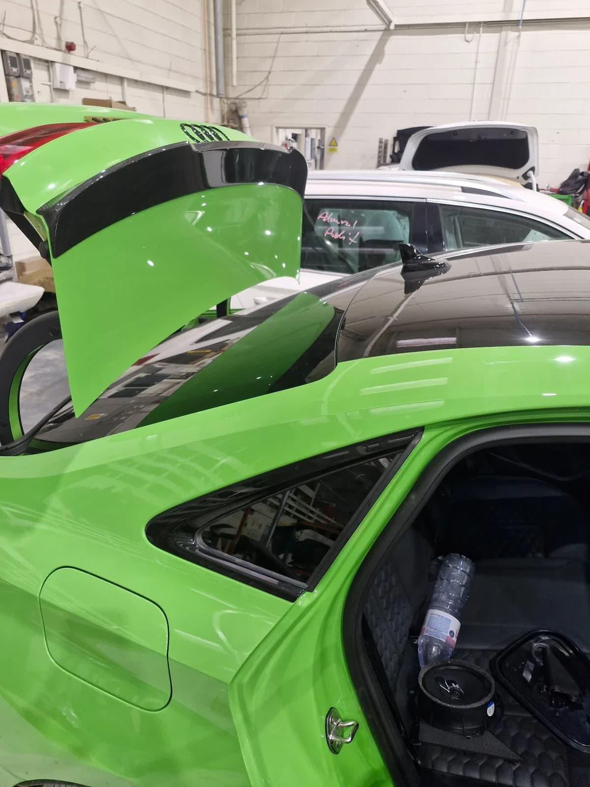 Rear quarter glass fitted to a green Audi.