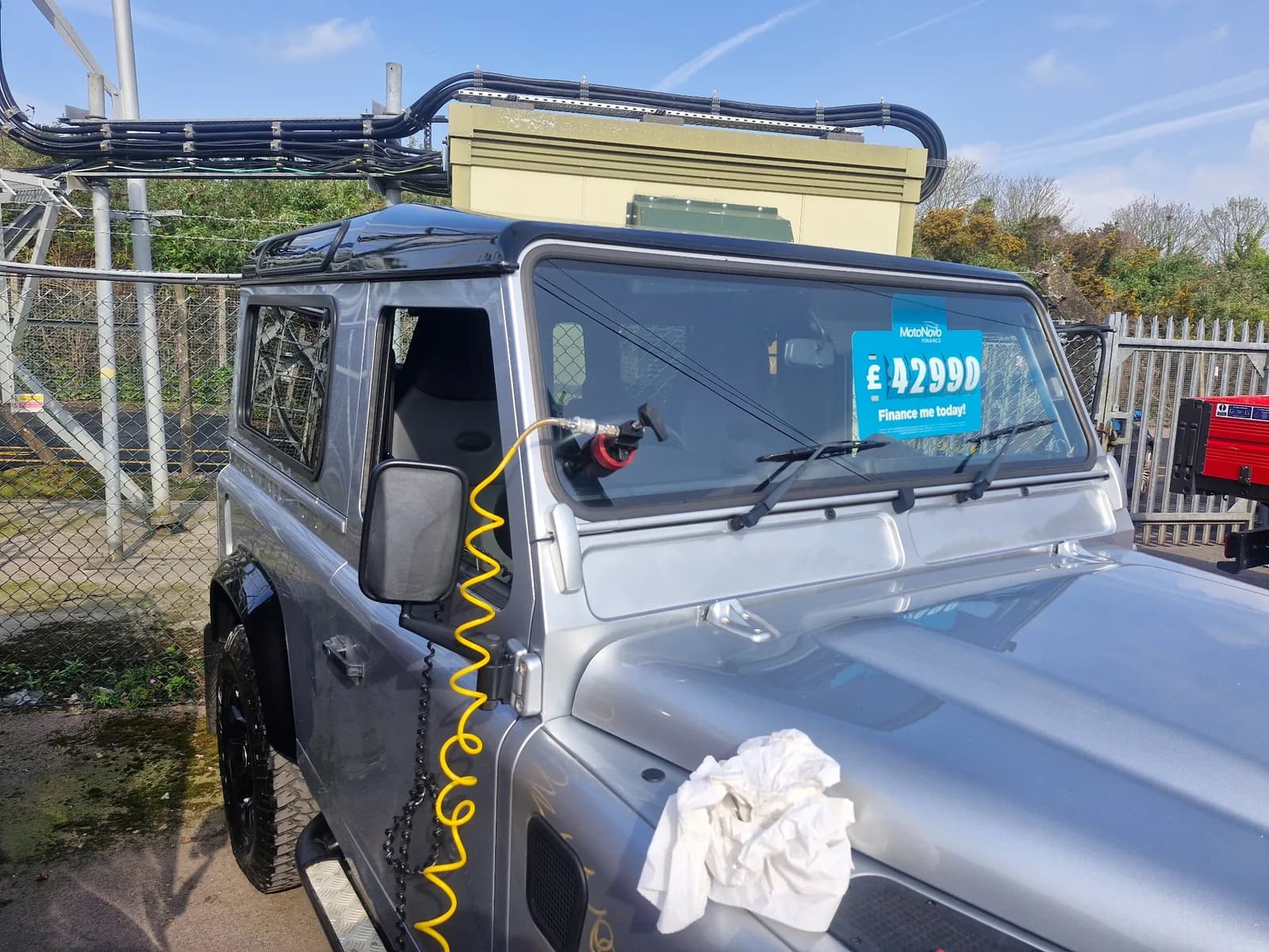 Stone chip repair equipment attached to a Land Rover Defender windscreen.