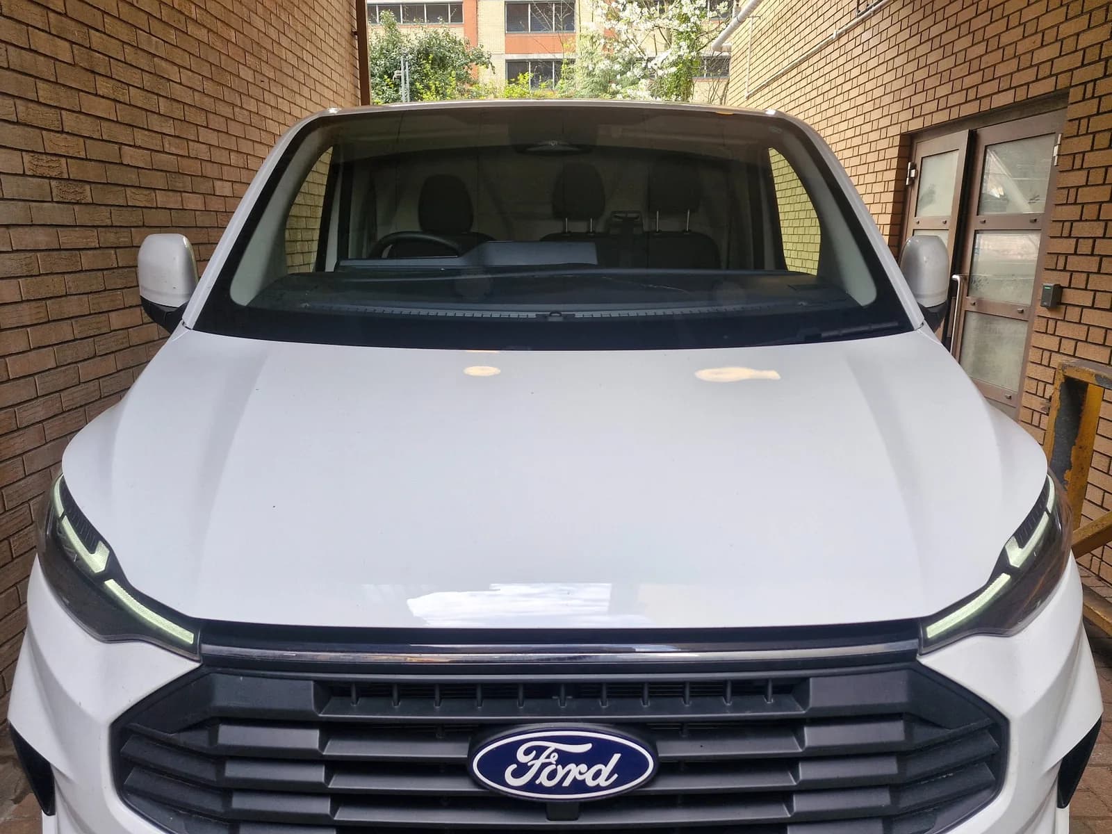 Windscreen fitted to a white Ford commercial van.