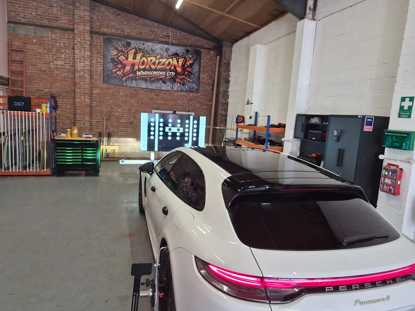 Modern vehicle inside the Horizon Windscreens workshop.